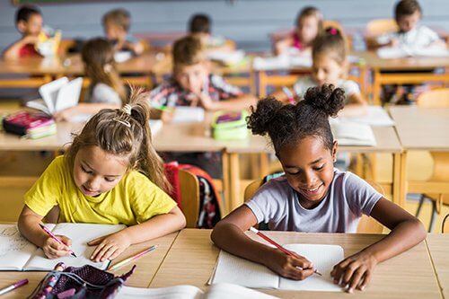 Children writing on a notebook